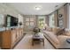 Comfortable living room with beautiful wallpaper, a stylish cabinet, and lots of natural light at 508 Boardwalk Way, Alpharetta, GA 30022