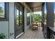 Charming outdoor porch area features a table and chairs for relaxing, shaded by the porch roof at 508 Boardwalk Way, Alpharetta, GA 30022