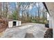 The backyard has ample parking, storage shed, and a wooded area beyond the lawn at 847 Magna Carta Nw Dr, Atlanta, GA 30318