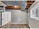 Partially finished basement showing exposed ductwork and ceiling, new flooring and a view into another room at 847 Magna Carta Nw Dr, Atlanta, GA 30318