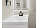 Close-up of the bathroom sink and illuminated mirror with black hardware and modern design at 847 Magna Carta Nw Dr, Atlanta, GA 30318