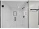 Modern bathroom featuring glass shower with black hardware, white tiles, and sleek, sophisticated design at 847 Magna Carta Nw Dr, Atlanta, GA 30318