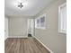 This bedroom features light gray walls, wood-look floors, and a modern light fixture at 847 Magna Carta Nw Dr, Atlanta, GA 30318