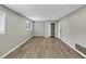 Large bedroom offers new wood floors, a neutral paint scheme, and natural light from the window at 847 Magna Carta Nw Dr, Atlanta, GA 30318