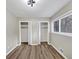 This well-lit bedroom features wood-look flooring, two closets, and a window at 847 Magna Carta Nw Dr, Atlanta, GA 30318