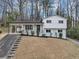 Charming two-story home with white exterior, covered porch, and well-maintained landscaping at 847 Magna Carta Nw Dr, Atlanta, GA 30318
