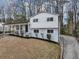A view of the house showing the landscaping and concrete driveway with a view of the side of the house at 847 Magna Carta Nw Dr, Atlanta, GA 30318