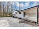 View of the home exterior showing the covered carport and spacious paved area at 847 Magna Carta Nw Dr, Atlanta, GA 30318