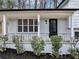 Charming front porch with updated landscaping and modern black door at 847 Magna Carta Nw Dr, Atlanta, GA 30318