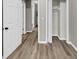 This hallway features modern paint and wood-look flooring with closets and doors at 847 Magna Carta Nw Dr, Atlanta, GA 30318