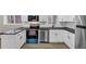 Kitchen area featuring stainless appliances, white cabinets, and a black countertop at 847 Magna Carta Nw Dr, Atlanta, GA 30318