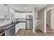 Bright kitchen features white cabinets, subway tile backsplash, stainless steel appliances, and wood-look flooring at 847 Magna Carta Nw Dr, Atlanta, GA 30318