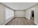 Bright, empty living room with new wood floors and large window with white blinds at 847 Magna Carta Nw Dr, Atlanta, GA 30318