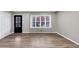 Spacious living room featuring new floors, large windows, and modern trim at 847 Magna Carta Nw Dr, Atlanta, GA 30318