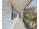 Long shot of the porch with white brick and railing and landscaping at 847 Magna Carta Nw Dr, Atlanta, GA 30318