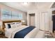 Bright staged bedroom with modern fixtures, closet space, and comfortable bedding at 1383 Almont Sw Dr, Atlanta, GA 30310