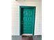 Stylish teal front door with classic hardware and sidelight paneling for a welcoming entrance at 9400 Roberts Dr # 6C, Atlanta, GA 30350