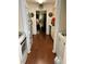 Hallway with hardwood flooring, and laundry on one side and kitchen on the other at 9400 Roberts Dr # 6C, Atlanta, GA 30350