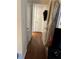 Hallway showcases hardwood flooring, leading to various rooms with neutral decor at 9400 Roberts Dr # 6C, Atlanta, GA 30350