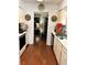 Kitchen with hardwood flooring that stretches into the adjacent living spaces at 9400 Roberts Dr # 6C, Atlanta, GA 30350