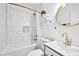 Modern bathroom featuring a bathtub, white subway tile, and a stylish vanity with gold fixtures at 966 Ashby Grove Sw St, Atlanta, GA 30314