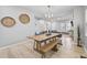 Inviting dining area with a large wooden table, bench seating, and modern light fixture at 966 Ashby Grove Sw St, Atlanta, GA 30314