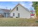 Rear exterior featuring white siding, a small yard, grill, and convenient access door at 966 Ashby Grove Sw St, Atlanta, GA 30314