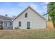 Rear exterior showcasing white siding, a small yard, and an access door at 966 Ashby Grove Sw St, Atlanta, GA 30314