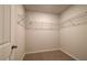 Empty walk-in closet with carpet flooring and wire shelving on the top perimeter at 113 Belvedere Rd, Mcdonough, GA 30253