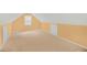 A carpeted attic room with built in storage, one window, and neutral walls at 1584 Snow Hill Dr, Lawrenceville, GA 30045