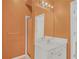 Well-lit bathroom featuring a single vanity, mirror, and shower at 1584 Snow Hill Dr, Lawrenceville, GA 30045
