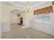 Elegant dining room boasts wainscoting, chandelier, and archway to a cozy living room with fireplace at 1584 Snow Hill Dr, Lawrenceville, GA 30045