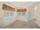 Bright dining room with wainscoting, chandelier, and large windows offering natural light at 1584 Snow Hill Dr, Lawrenceville, GA 30045