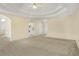 Spacious carpeted living room with trey ceiling, and open access to the kitchen and dining areas at 1584 Snow Hill Dr, Lawrenceville, GA 30045