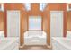 Bright bathroom with a soaking tub, double vanity, and window at 1584 Snow Hill Dr, Lawrenceville, GA 30045