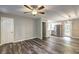 Open-concept living room and kitchen featuring wood-look floors and modern light fixtures at 4973 White Blvd, Mableton, GA 30126