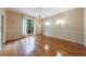 Classic living room featuring hardwood floors, a chandelier, and a large window at 1 Ansley Ne Dr, Atlanta, GA 30309