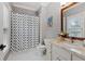 Chic bathroom with a patterned shower curtain, granite vanity, and ample natural light from the window at 2728 Long Grove Dr, Marietta, GA 30062