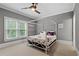 Cozy bedroom with a four-poster bed, soft carpeting, and serene natural light from the windows at 2728 Long Grove Dr, Marietta, GA 30062