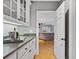 Well-appointed butler's pantry with white cabinetry offers a stylish transition to the modern kitchen at 2728 Long Grove Dr, Marietta, GA 30062