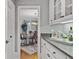 Charming butler's pantry with white cabinets and elegant dining room view creates a seamless transition between spaces at 2728 Long Grove Dr, Marietta, GA 30062