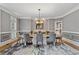 Elegant dining room with sophisticated wainscoting, a stylish rug, and a modern chandelier at 2728 Long Grove Dr, Marietta, GA 30062