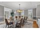 Formal dining room with a modern chandelier, wainscoting, and large windows offering ample natural light at 2728 Long Grove Dr, Marietta, GA 30062