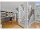 Open-concept interior showcases the staircase and kitchen, with hardwood floors and white trim throughout at 2728 Long Grove Dr, Marietta, GA 30062
