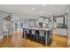 Open kitchen showcases an island with barstool seating, stainless steel appliances, and custom white cabinetry at 2728 Long Grove Dr, Marietta, GA 30062