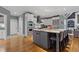 Open kitchen featuring stainless steel appliances, a large island, and barstool seating, flowing into the living area at 2728 Long Grove Dr, Marietta, GA 30062