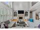 Elegant living room featuring a stone fireplace, built-in shelving, and stylish neutral-toned furniture at 2728 Long Grove Dr, Marietta, GA 30062