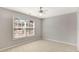 Bedroom with a ceiling fan and a bright window overlooking the backyard at 30 Barbara Ct, Fayetteville, GA 30215