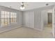 Bright bedroom featuring a ceiling fan, a double door closet, and a large window with natural light at 30 Barbara Ct, Fayetteville, GA 30215