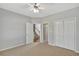 Bedroom features neutral carpet, double door closet, and door to access the stairs at 30 Barbara Ct, Fayetteville, GA 30215